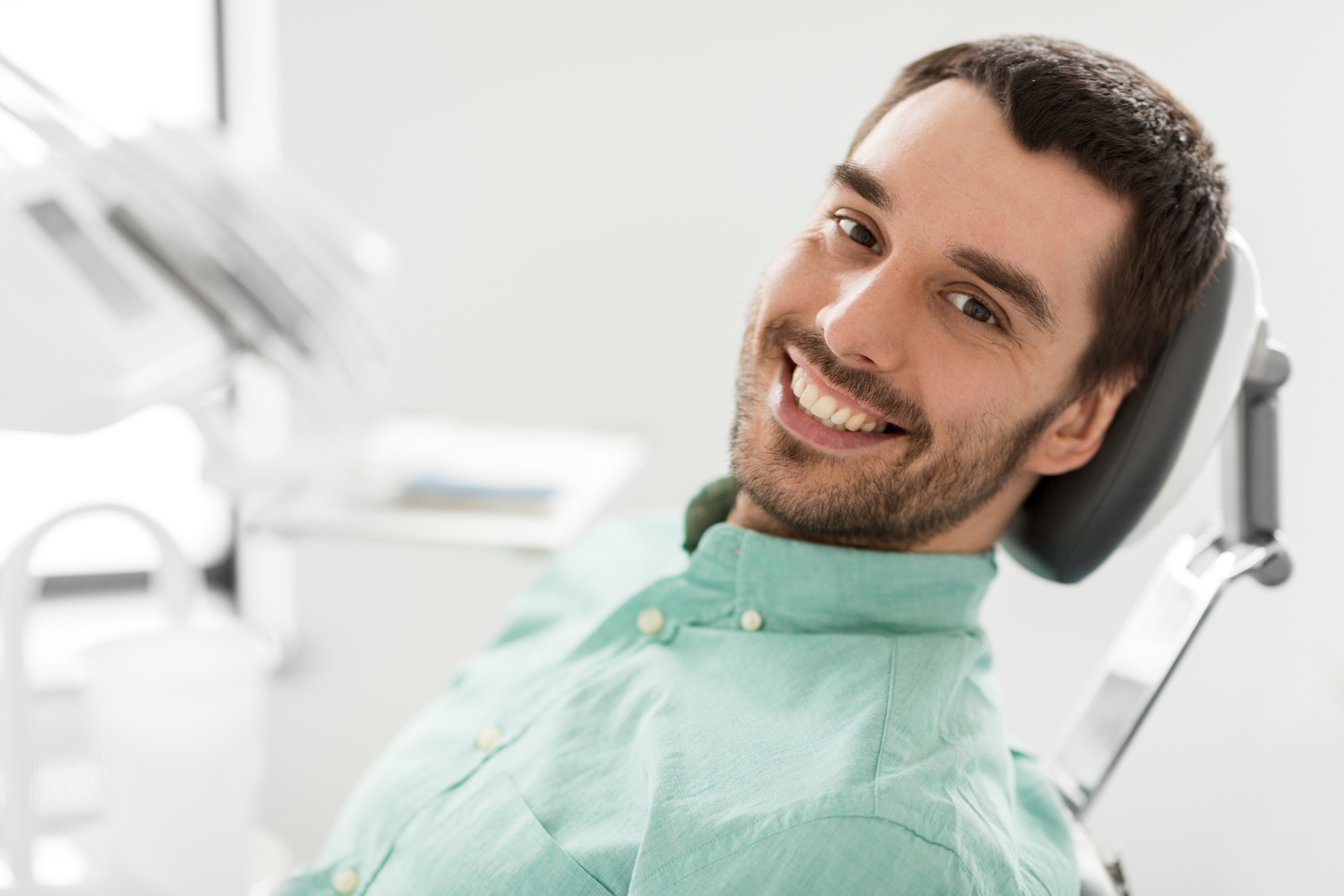 happy smiling male patient at dental clinic - Stovall & Cheng DDS, PLLC